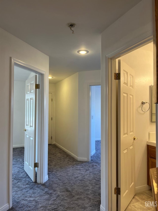 corridor with dark colored carpet