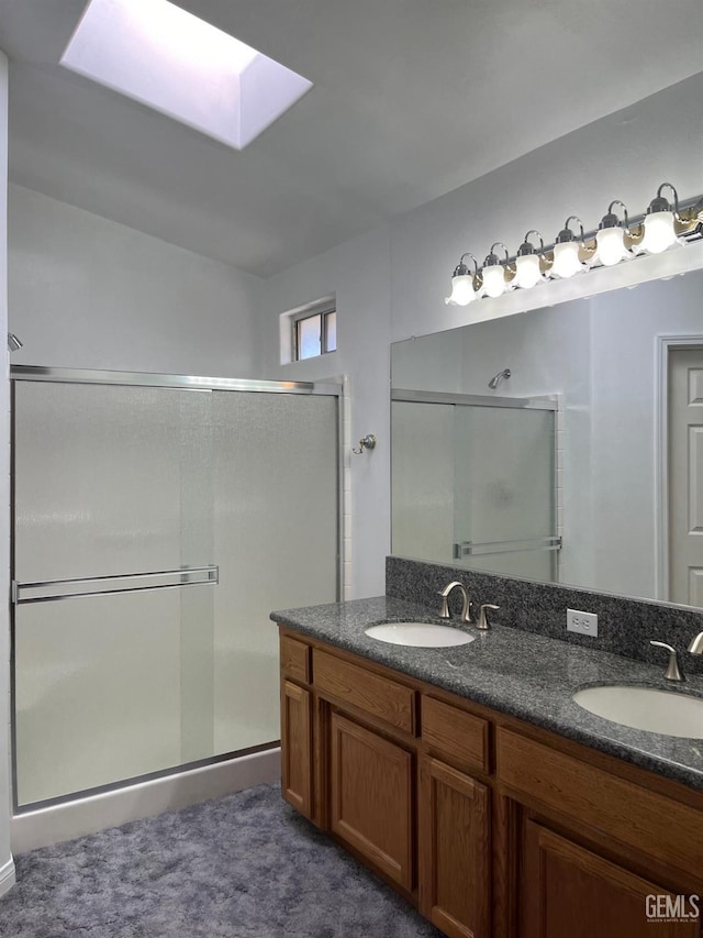 bathroom with vanity, a skylight, and walk in shower