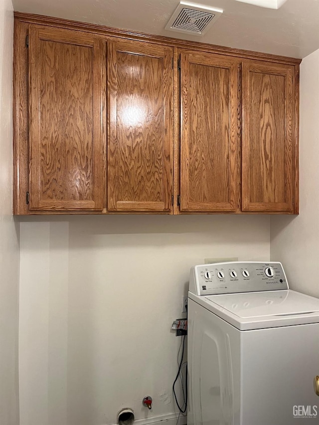 laundry room with cabinets and washer / clothes dryer