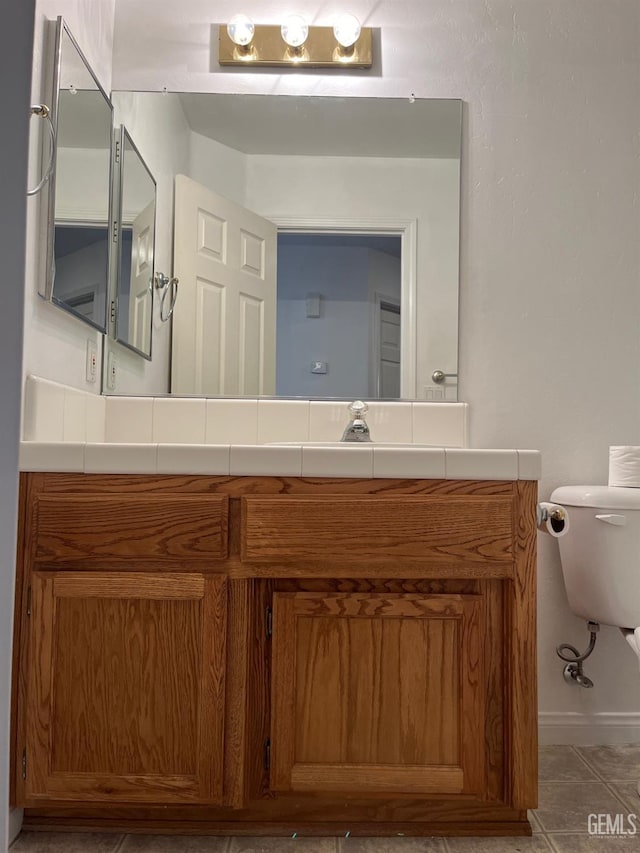 bathroom with vanity and tile patterned floors