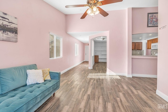 living room featuring ceiling fan and hardwood / wood-style flooring