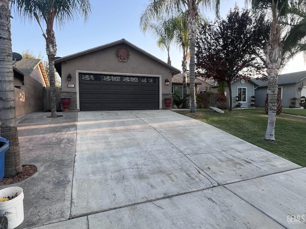 ranch-style home featuring a front yard and a garage