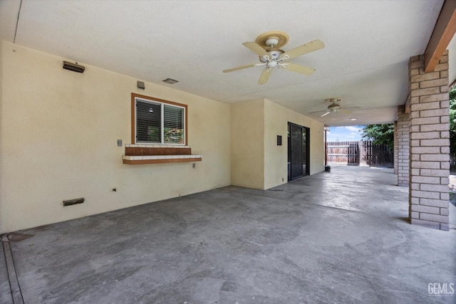 view of patio with fence and a ceiling fan