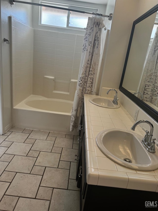 bathroom featuring vanity and shower / bathtub combination with curtain