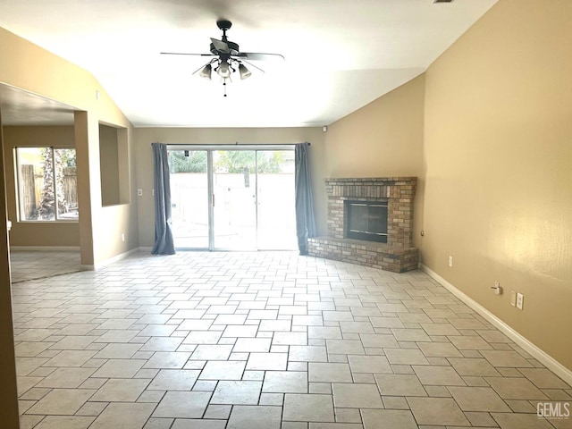 unfurnished living room featuring ceiling fan, a healthy amount of sunlight, lofted ceiling, and a fireplace