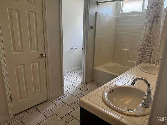 bathroom with tile patterned flooring, shower / tub combo, and vanity