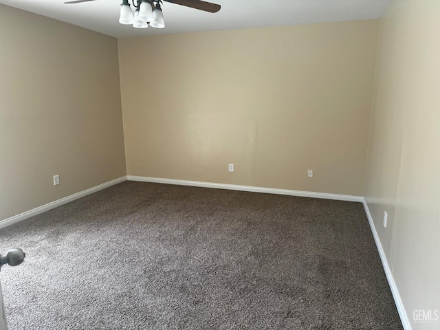 carpeted spare room featuring ceiling fan