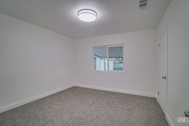 empty room featuring baseboards, visible vents, and carpet flooring