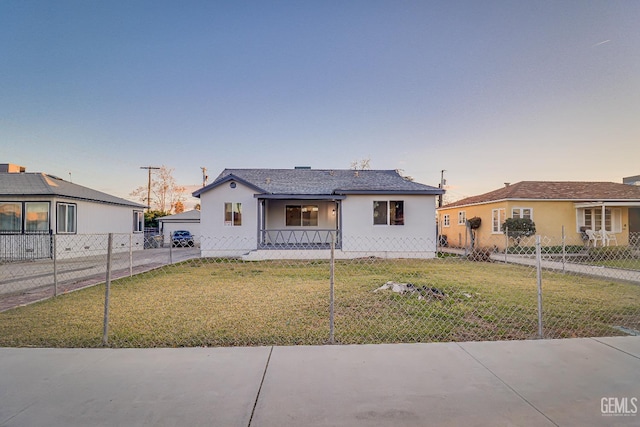 view of front of home featuring fence, a porch, a lawn, and stucco siding