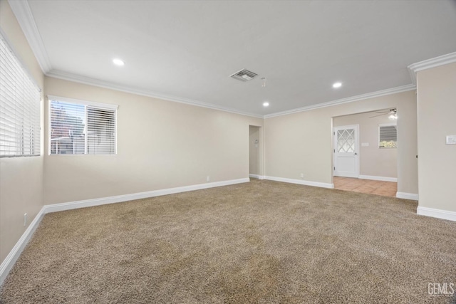 empty room with crown molding, ceiling fan, and light carpet