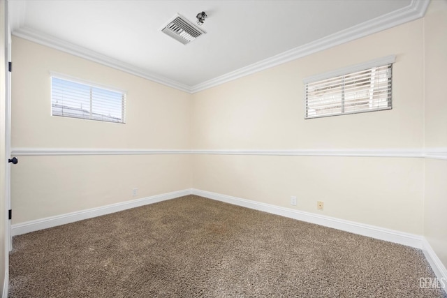 unfurnished room with ornamental molding and carpet floors