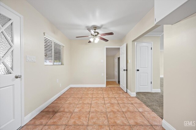 empty room featuring light colored carpet, plenty of natural light, and ceiling fan