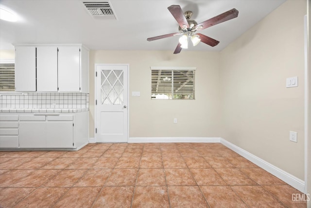 interior space with ceiling fan and light tile patterned floors