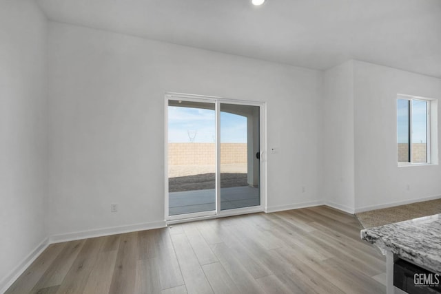 8407 Seth Alexander Way, Bakersfield, CA 93306 - unfurnished living room featuring light wood-style flooring, baseboards, and recessed lighting