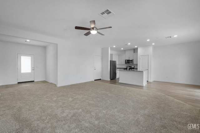 8407 Seth Alexander Way, Bakersfield, CA 93306 - unfurnished living room featuring recessed lighting, a ceiling fan, light colored carpet, and baseboards