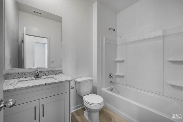 8407 Seth Alexander Way, Bakersfield, CA 93306 - bathroom featuring wood finished floors, vanity, toilet, and shower / bath combination