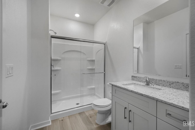 8407 Seth Alexander Way, Bakersfield, CA 93306 - full bath featuring toilet, a shower stall, vanity, and wood finished floors