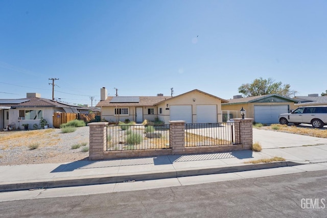 ranch-style house featuring solar panels and a garage