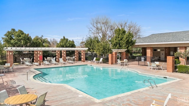 community pool featuring a patio area, fence, and a pergola