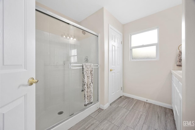 full bath featuring baseboards and a stall shower