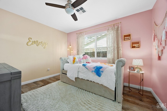 bedroom featuring visible vents, baseboards, and wood finished floors