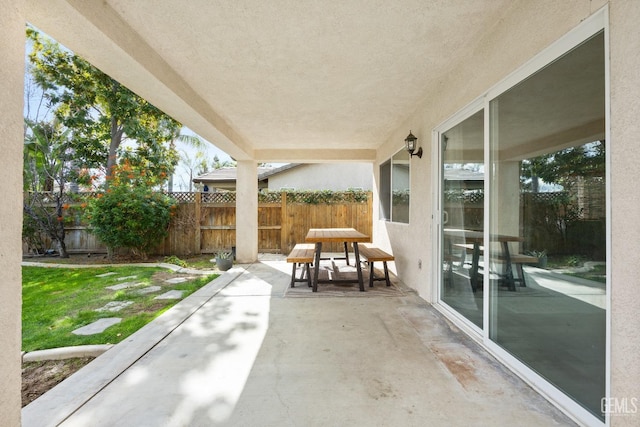 view of patio / terrace with outdoor dining space and fence