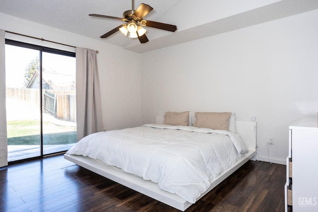 bedroom featuring access to exterior, ceiling fan, and dark wood-type flooring