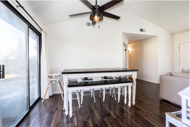 dining area featuring ceiling fan, dark wood-type flooring, a textured ceiling, and lofted ceiling