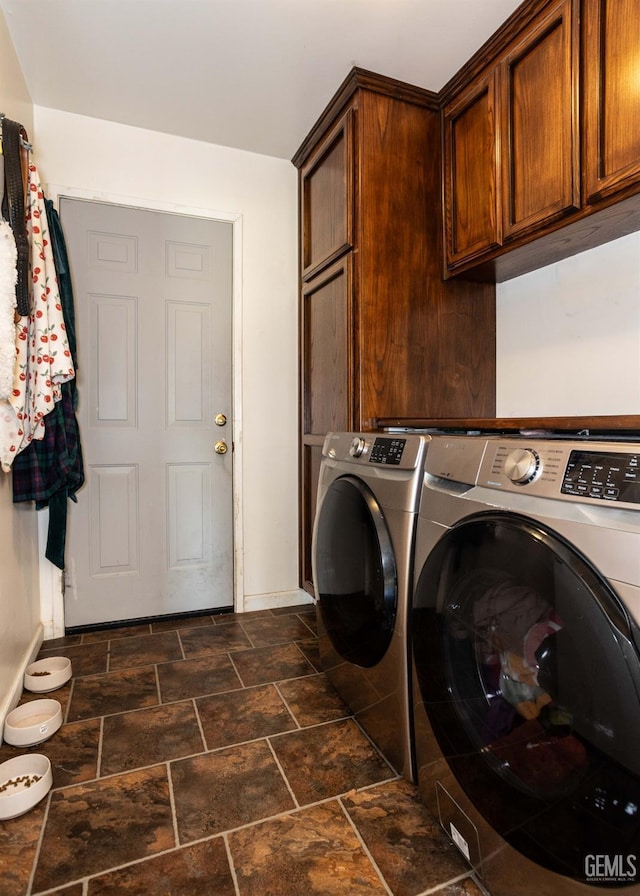 laundry area featuring cabinets and washing machine and clothes dryer