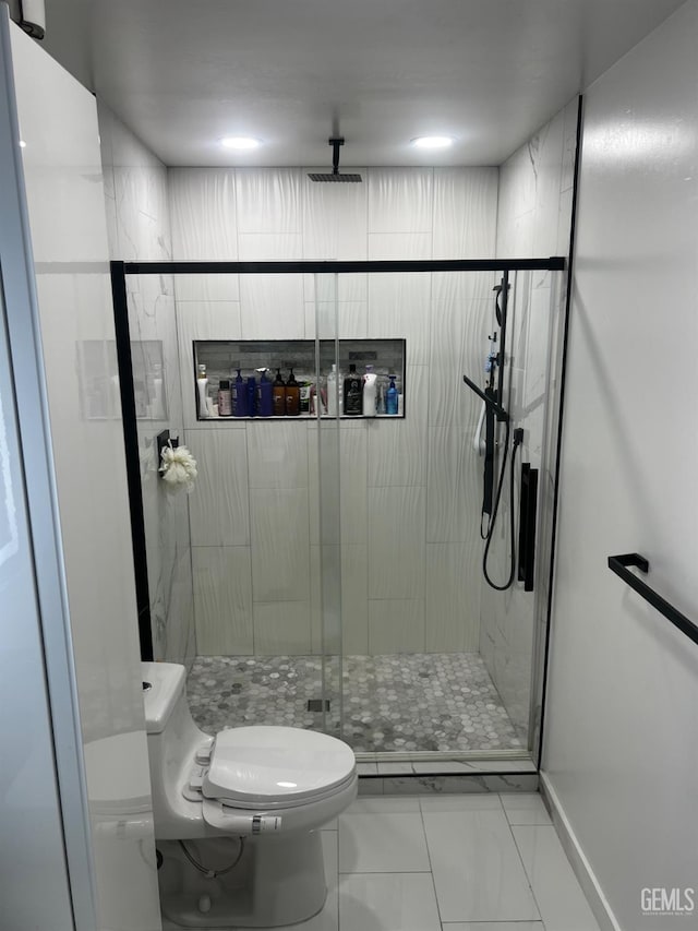 bathroom with an enclosed shower and toilet