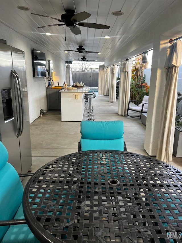 view of patio with a bar and ceiling fan