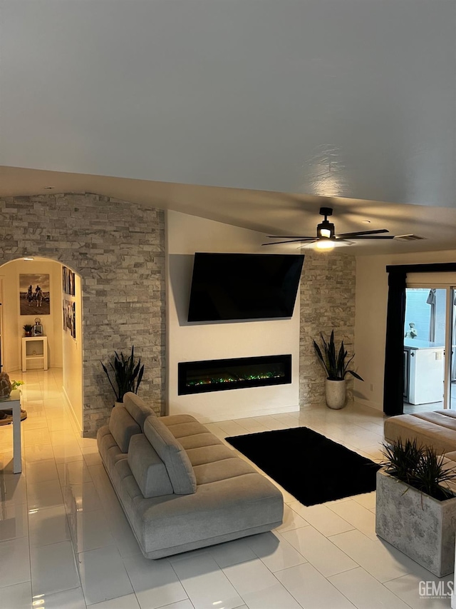 living room featuring washer / clothes dryer, light tile patterned floors, and ceiling fan