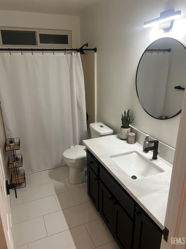 bathroom featuring tile patterned floors, vanity, and toilet