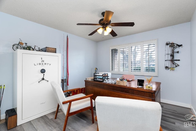 office with ceiling fan, a textured ceiling, baseboards, and wood finished floors