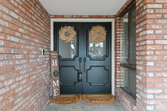 doorway to property with brick siding