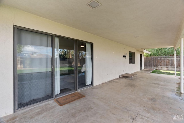 view of patio featuring fence