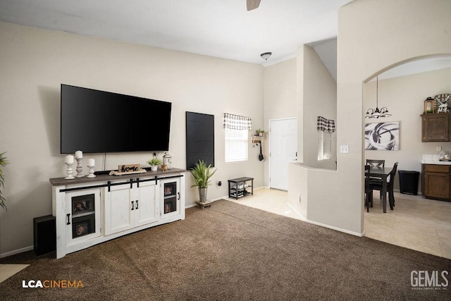 carpeted living area with baseboards and tile patterned floors