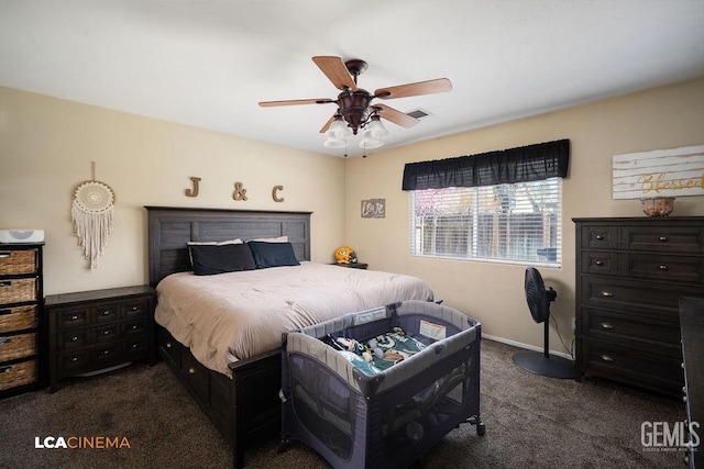 bedroom featuring a ceiling fan, dark colored carpet, visible vents, and baseboards