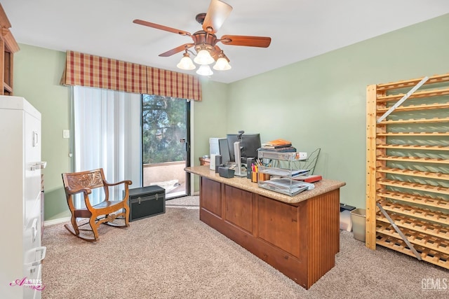 carpeted office featuring ceiling fan