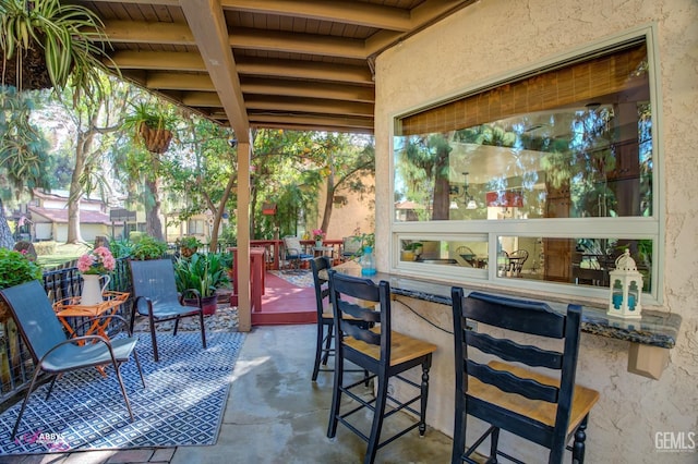 view of patio / terrace featuring a deck and an outdoor bar