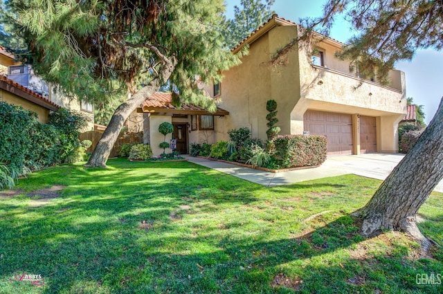 mediterranean / spanish-style home featuring a garage and a front yard