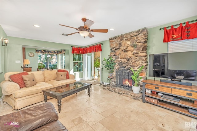 living room with a fireplace and ceiling fan