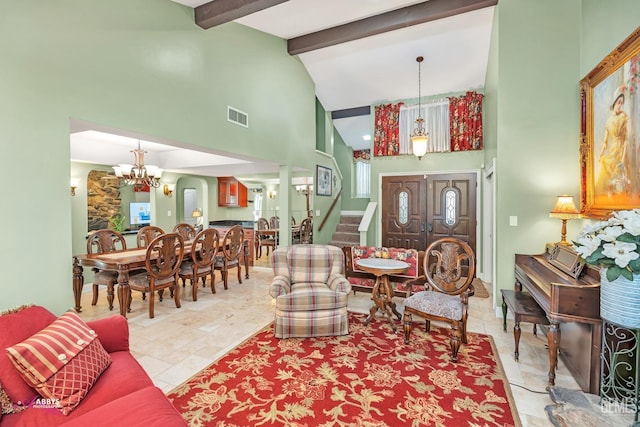 living room featuring an inviting chandelier, beam ceiling, and high vaulted ceiling