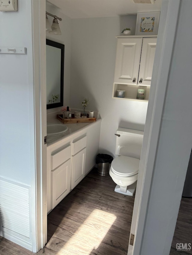 5308 Eastridge Ct, Bakersfield, CA 93306 - half bath featuring vanity, toilet, and wood finished floors