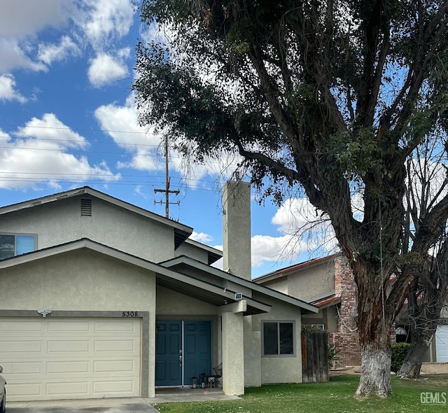5308 Eastridge Ct, Bakersfield, CA 93306 - view of front of property featuring stucco siding, an attached garage, and a chimney