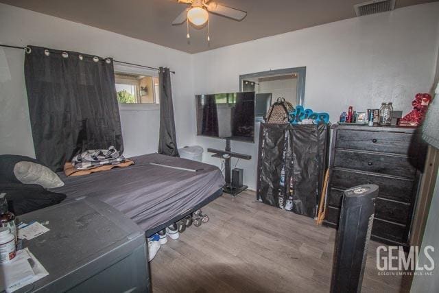 bedroom featuring ceiling fan and wood-type flooring