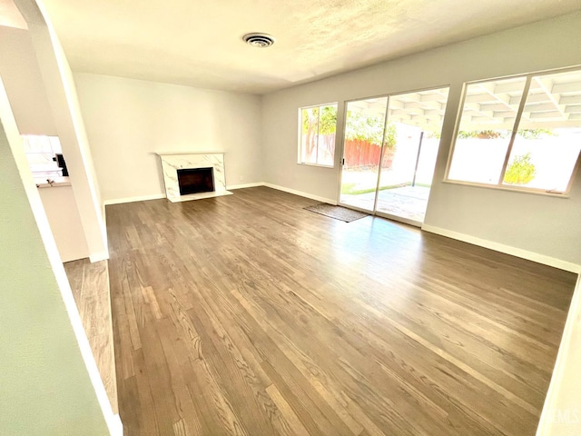 2301 Tangerine St, Bakersfield, CA 93306 - unfurnished living room featuring wood finished floors and a fireplace