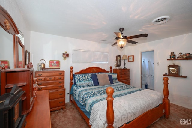 bedroom featuring ceiling fan, light carpet, and a textured ceiling