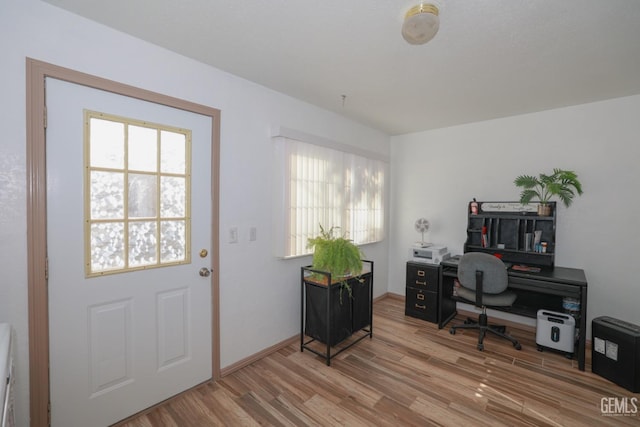 office space featuring wood-type flooring and a healthy amount of sunlight