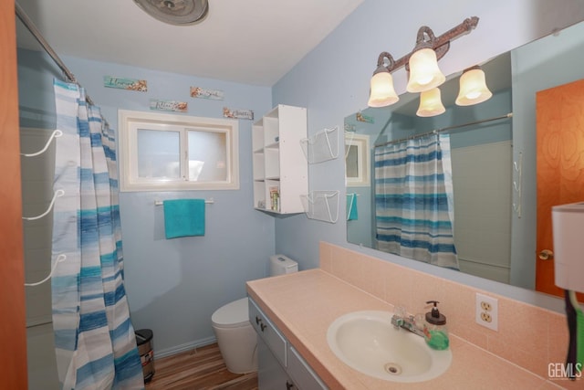 bathroom featuring hardwood / wood-style flooring, vanity, and toilet